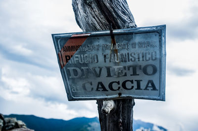 Low angle view of road sign against sky