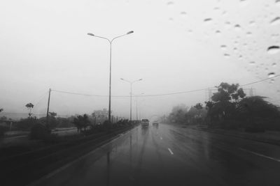 Cars on road against sky