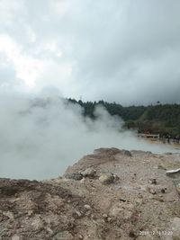 Scenic view of clouds over mountain against sky