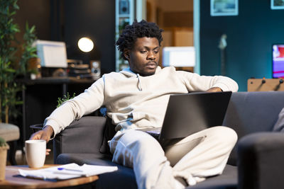 Young man using laptop at home