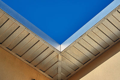 A low angle view of a roof with a blue sky