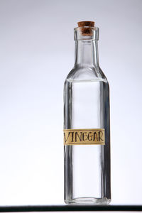 Close-up of glass bottle against white background