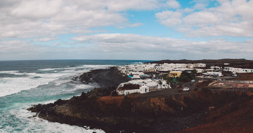 View of beach against cloudy sky