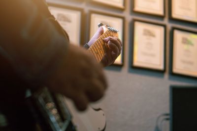 Cropped hands of person playing guitar