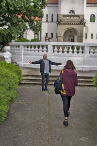 Rear view of women walking on footpath