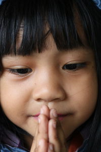 Close-up of cute girl looking down