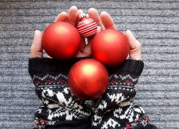 Cropped hands holding baubles during christmas