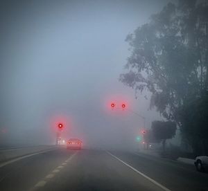 Cars on road against sky