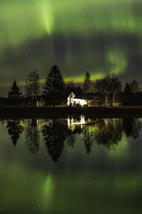 Scenic view of lake against sky at night