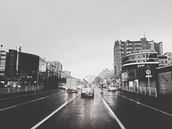 Road in city against clear sky