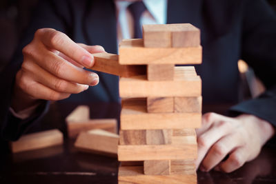 Close-up of man playing with toy on table