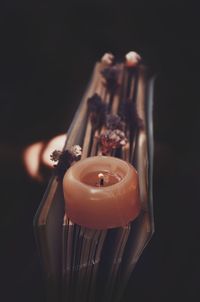 Close-up of tea light candle on black background