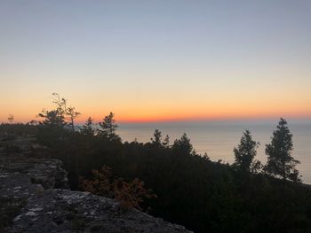 Scenic view of sea against orange sky