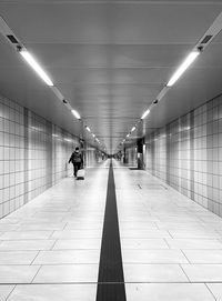 Rear view of woman walking on subway station