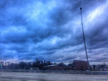 View of street against cloudy sky