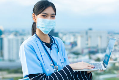 Portrait of beautiful young woman in city
