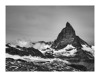 Scenic view of snowcapped mountain against sky