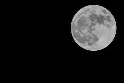 Low angle view of moon against clear sky at night