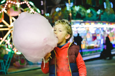 Portrait of cute boy eating cotton candy