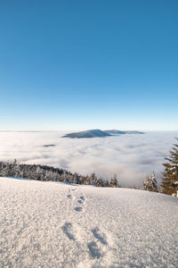 Scenic view of snow covered landscape against clear sky