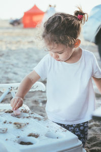 Full length of cute girl eating food