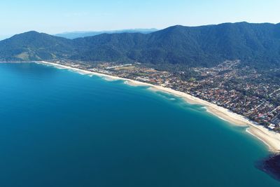 Aerial view of sea against blue sky