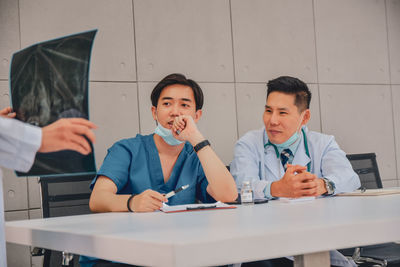 Portrait of friends sitting on table