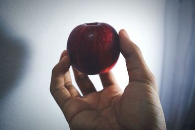 Close-up of hand holding strawberry