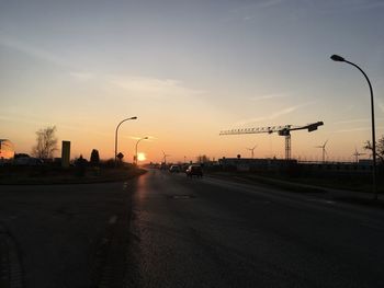 Street against sky at sunset