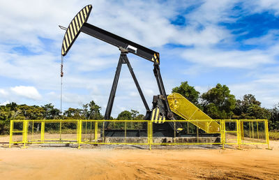 Oil pump against cloudy sky