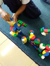 Low section of people playing with toy