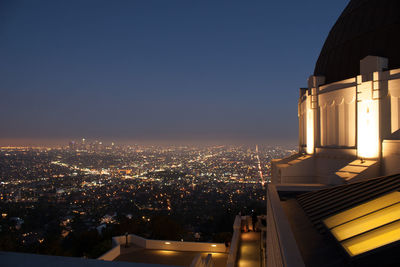 High angle view of illuminated buildings against sky at night