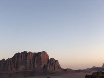 Rock formations on landscape against clear sky