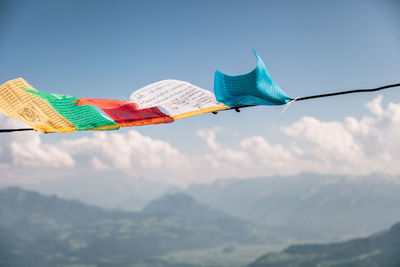 Low angle view of flags against mountain range
