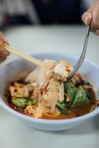 Close-up of hand holding food in plate