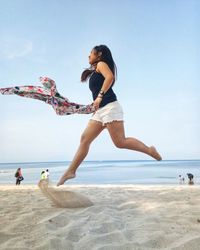 People on beach against sky