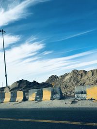 Road by city against blue sky
