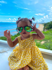 Portrait of a baby girl wearing sunglasses