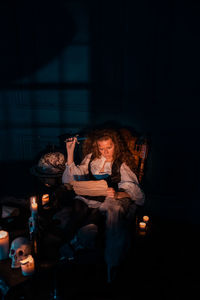Woman sitting in the dark