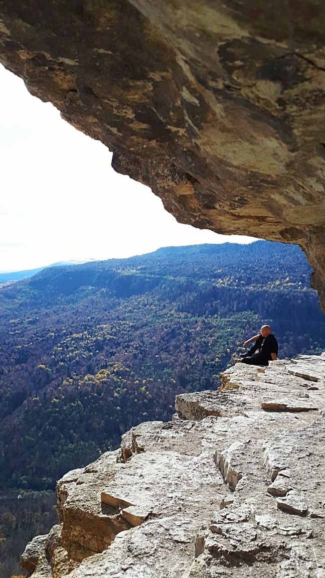 rock, rock - object, solid, one person, mountain, beauty in nature, real people, rock formation, leisure activity, day, nature, lifestyles, scenics - nature, adventure, activity, tranquility, mountain range, non-urban scene, tranquil scene, outdoors