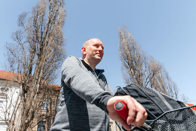 Portrait of a handsome hipster man. a man in a big city cycling down the street on a bicycle