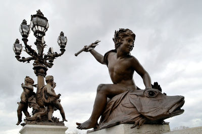 Low angle view of statue against sky