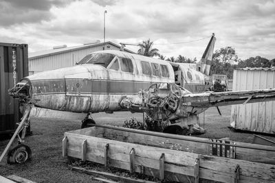 Abandoned airplane at construction site against sky