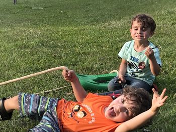 Happy siblings playing on field