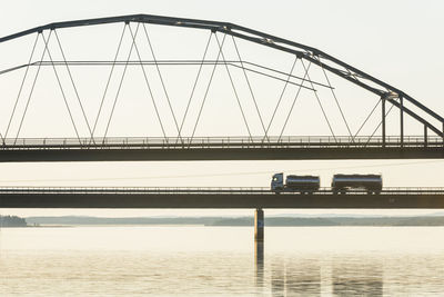 Lorry driving through bridge at dusk