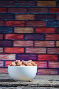 Close-up of salted almonds in bowl on table