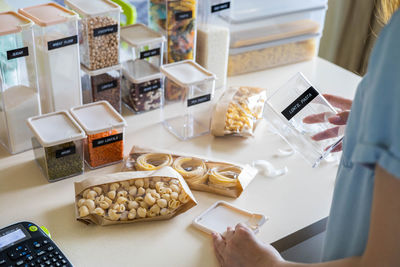 Midsection of woman packing food in container