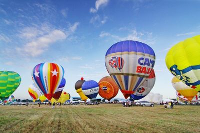 Hot air balloons on grassy field