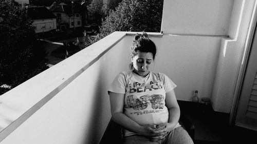 Pregnant woman sitting in balcony