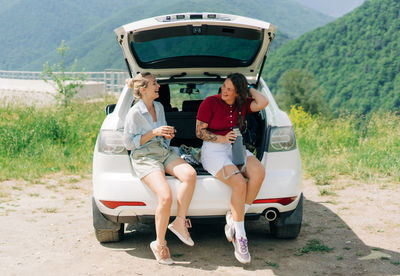 Side view of man sitting in car